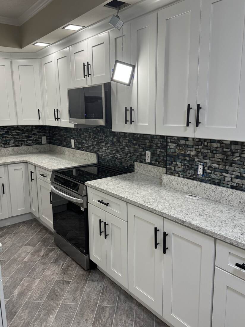 Kitchen with white cabinets and tile backsplash