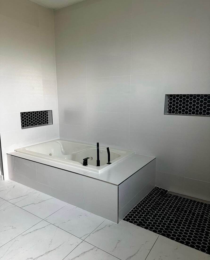 Soaking tub with hexagon tile niche